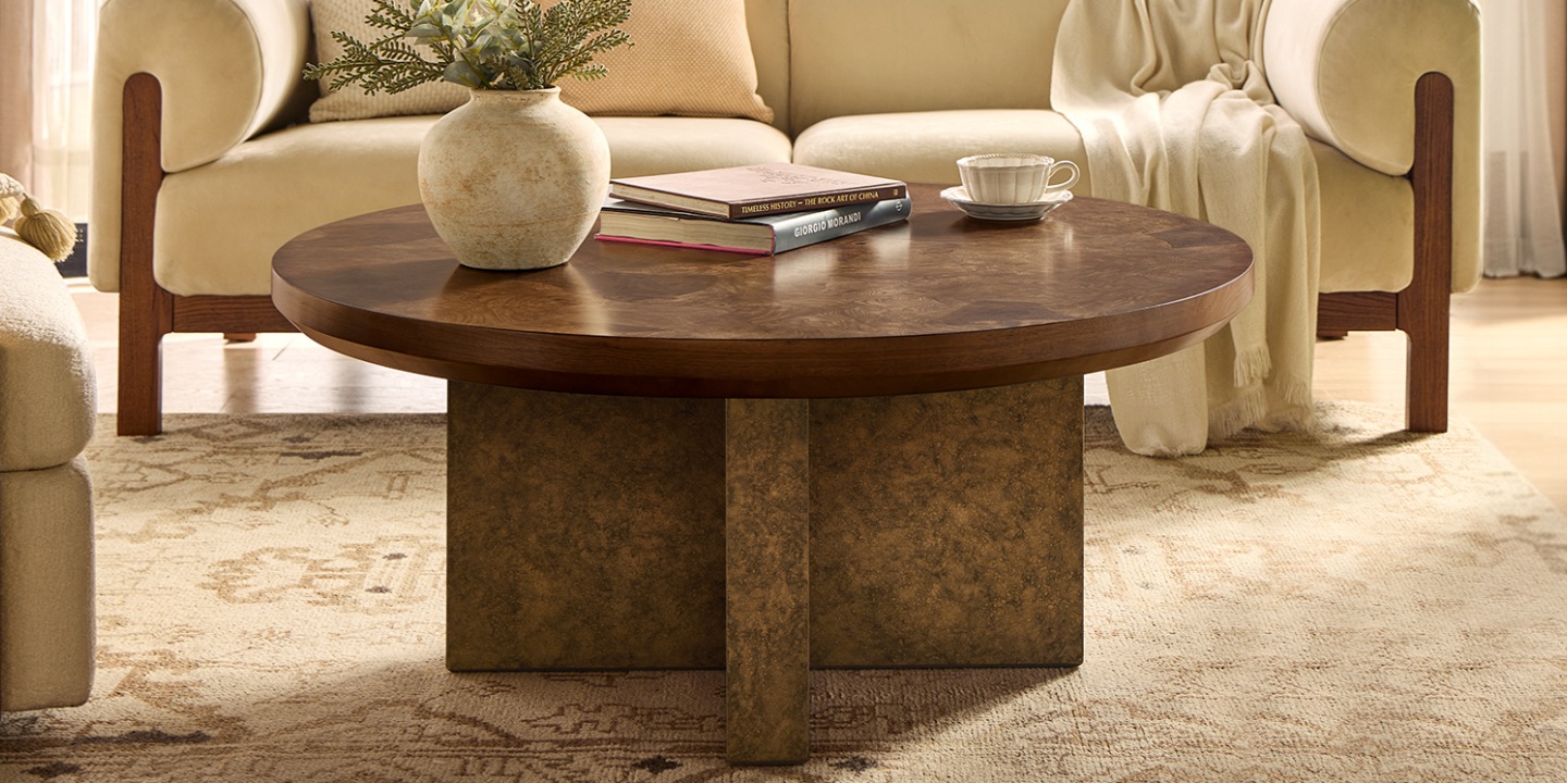 Colle 42" wide round coffee table with an American walnut burl veneer top and a cross-shaped pedestal.