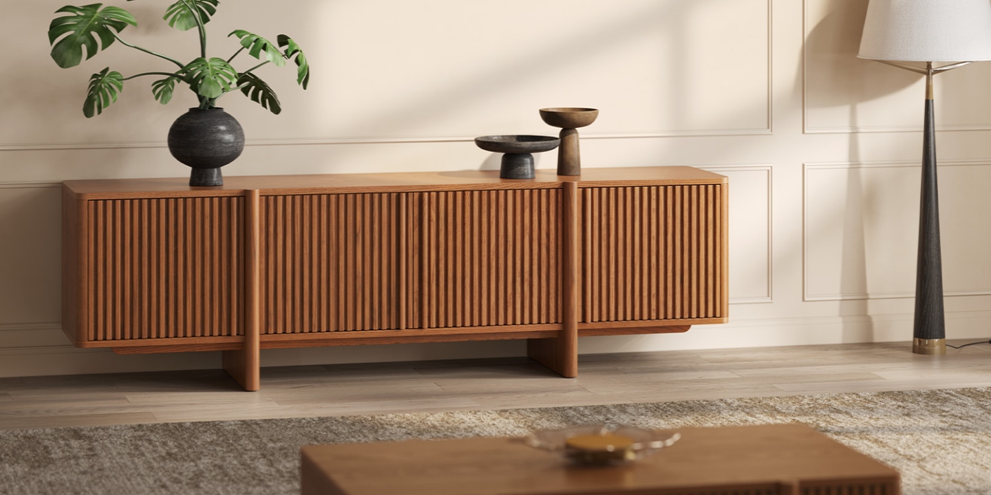 A Sabina 84 inch Ash Wood Media Console in a peaceful feng shui living room with a healthy Monstera plant and simple decor.