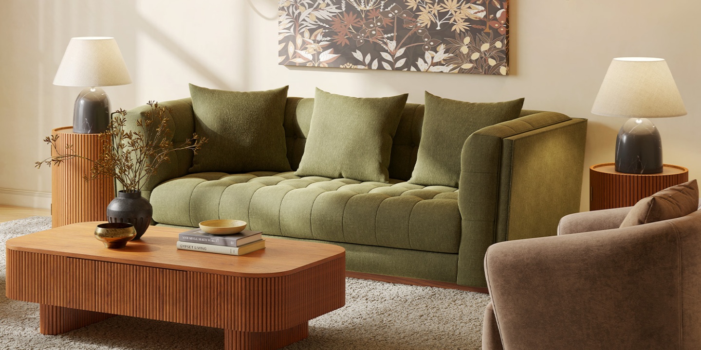 Mid-century modern Enkel sofa upholstered in rifle green chenille fabric with a tufted silhouette and oak base in a living room interior
