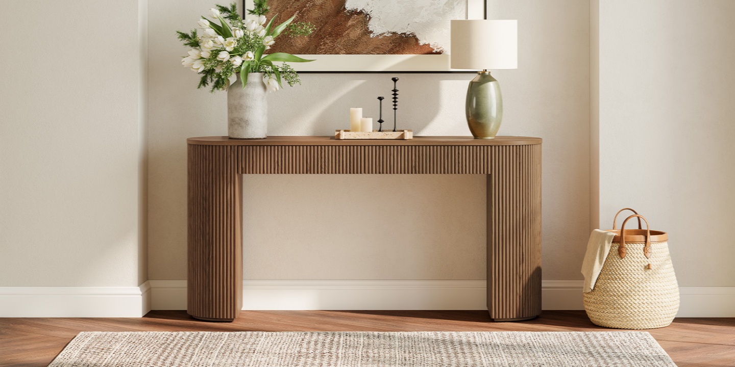 Asophisticated dark oak console table with a minimalist, fluted, rounded-edge design. The piece is styled against a neutral wall with a vibrant white floral arrangement, a modern ceramic table lamp, and minimalist decor.