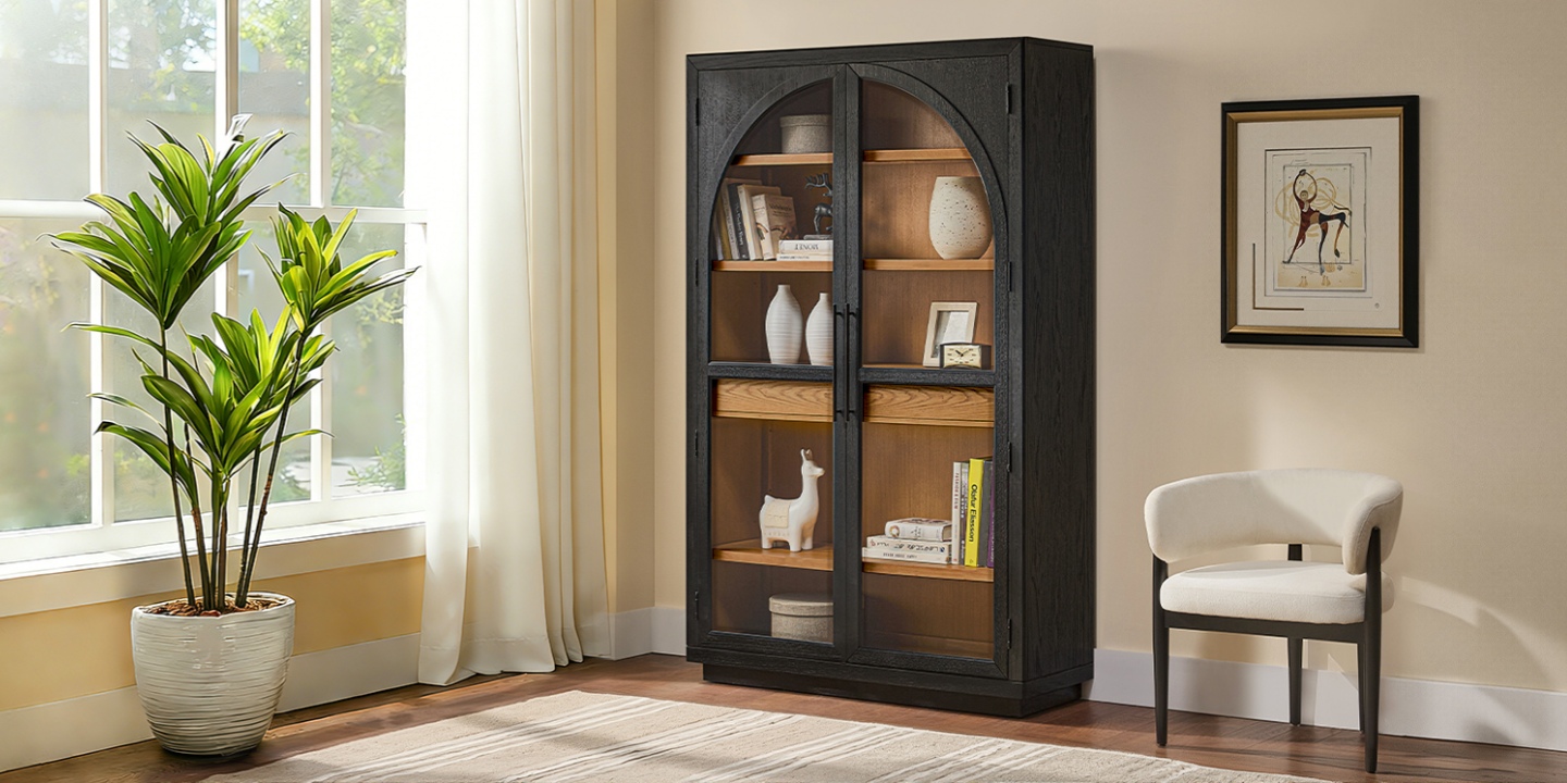 47-inch Valborg bookcase with arched black doors, warm oak shelves, and decor, placed in a bright, modern living room interior. 47-inch Valborg bookcase with arched black doors, warm oak shelves, and decor, placed in a bright, modern living room interior.