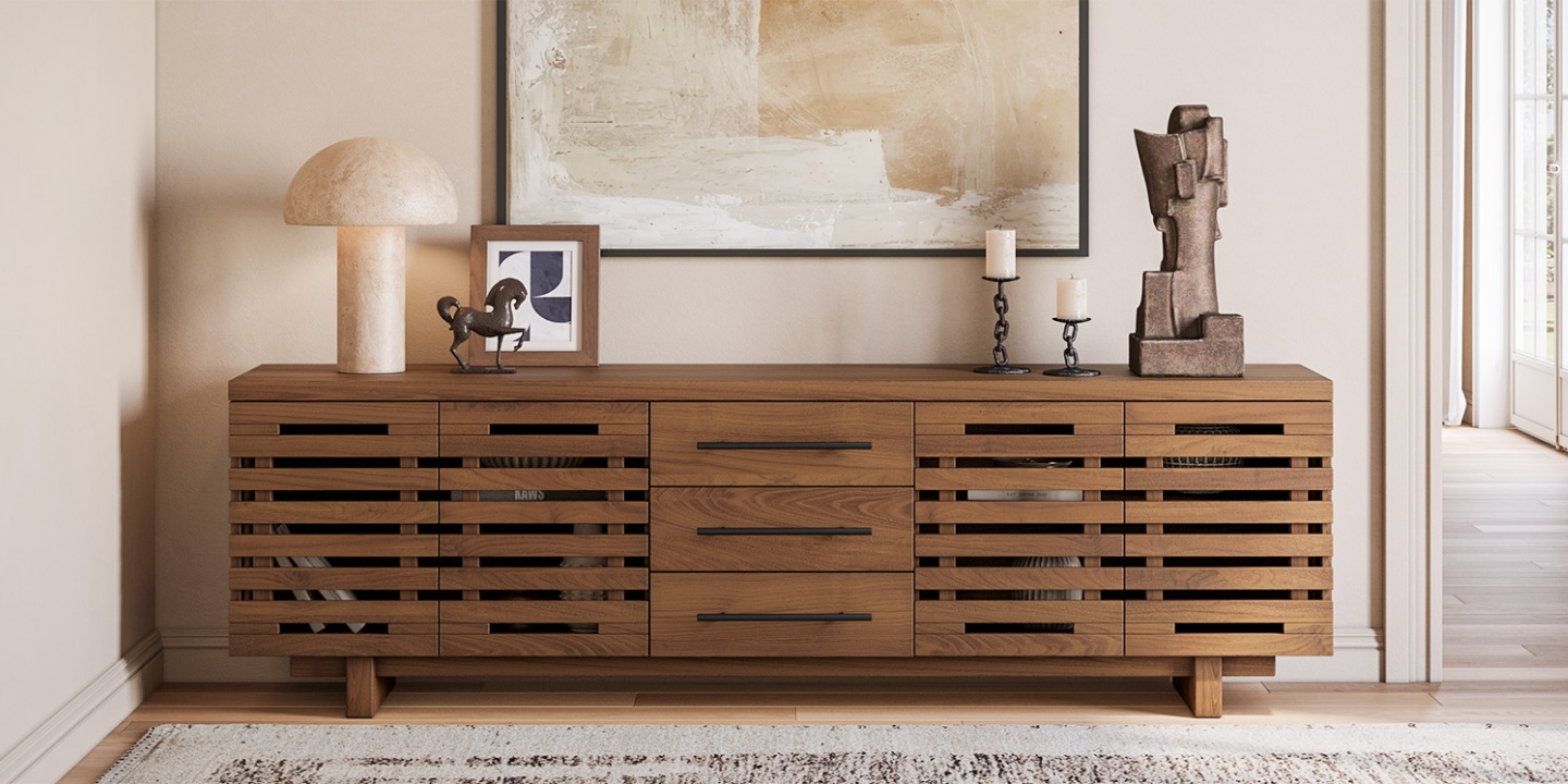 An elm wood slatted media console for 75-inch TVs styled with a mushroom lamp, artwork, and decor. An elm wood slatted media console for 75-inch TVs styled with a mushroom lamp, artwork, and decor.