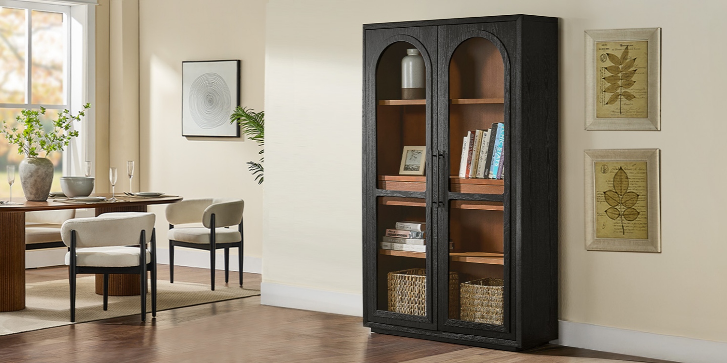 47-inch Lira black oak bookcase with arched glass doors and wood shelves, styled with home decor in a bright, modern dining room. 47-inch Lira black oak bookcase with arched glass doors and wood shelves, styled with home decor in a bright, modern dining room.