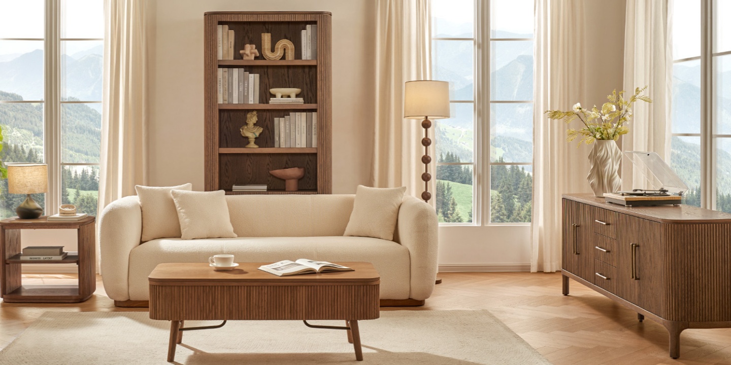 Skugga 84.4-inch tall oak cabinet with hammered brass pulls, set in a modern living room scene with a sofa. Skugga 84.4-inch tall oak cabinet with hammered brass pulls, set in a modern living room scene with a sofa.