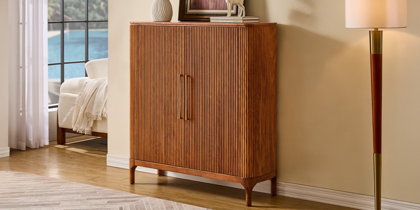 Skugga 47-inch oak shoe storage cabinet featuring fluted wood doors and long brass pulls in a bright entryway. Skugga 47-inch oak shoe storage cabinet featuring fluted wood doors and long brass pulls in a bright entryway.