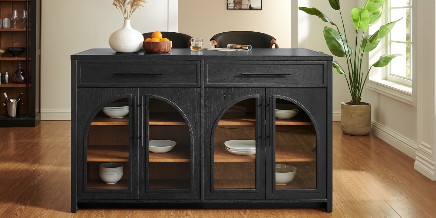The 63-inch black Valborg kitchen island features arched glass doors and drawers, styled with decor and paired with counter stools in a bright room. The 63-inch black Valborg kitchen island features arched glass doors and drawers, styled with decor and paired with counter stools in a bright room.