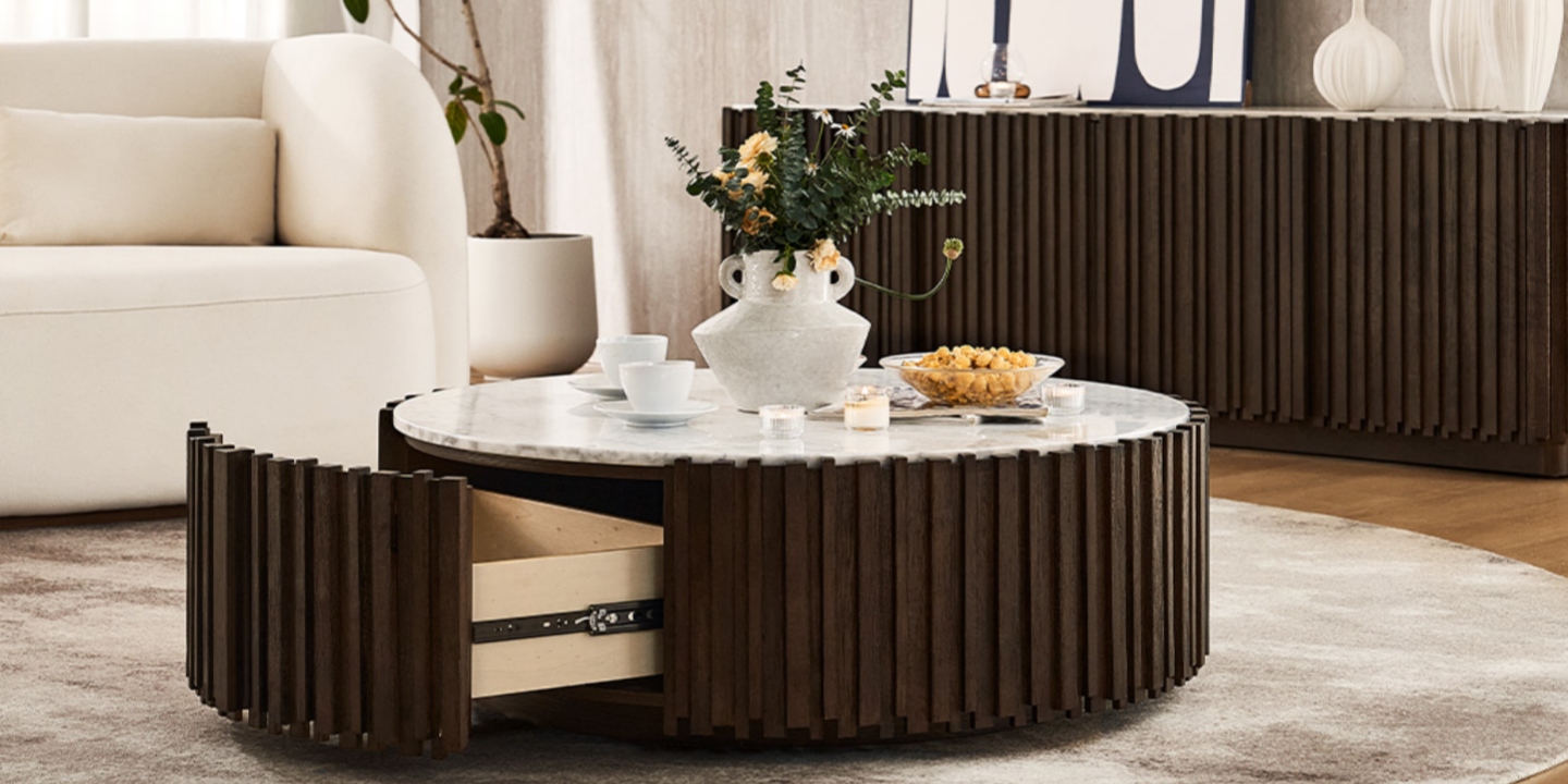 Armonia 41" Carrara marble coffee table with fluted wood base, showing an open drawer in a modern living room setting. Armonia 41" Carrara marble coffee table with fluted wood base, showing an open drawer in a modern living room setting.