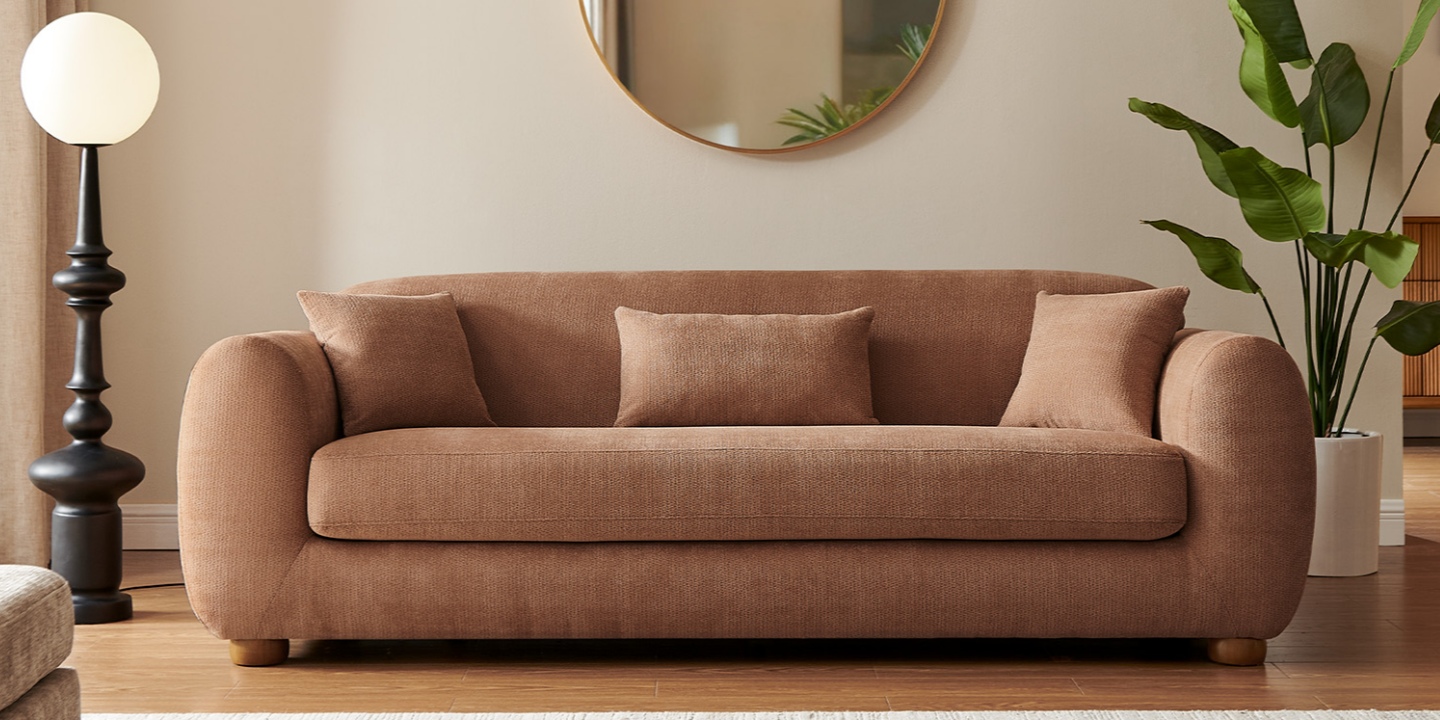 This deep couch provides cozy seating, styled with plush pillows and a modern floor lamp in a warm room. This deep couch provides cozy seating, styled with plush pillows and a modern floor lamp in a warm room.