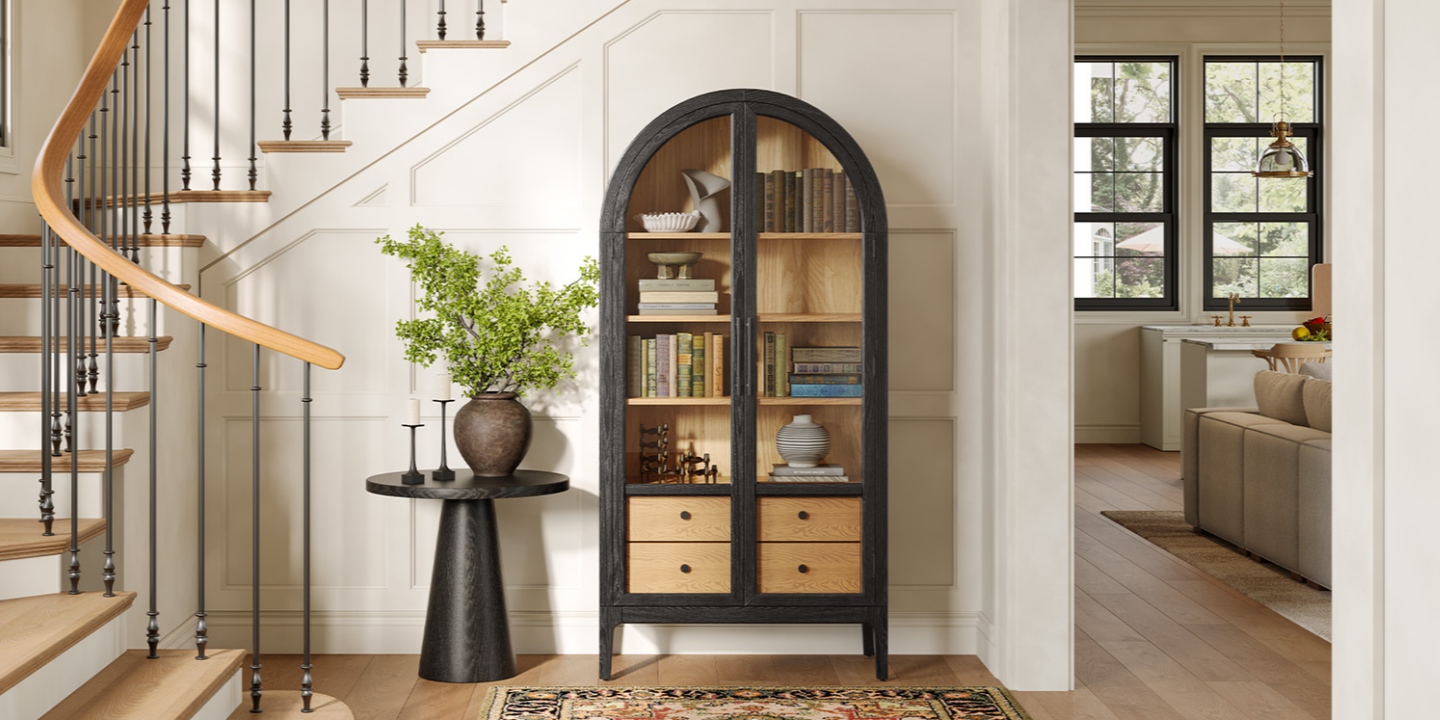 Placed near a staircase, this arched black cabinet features glass doors and shelves ideal for stuffed animal storage. Placed near a staircase, this arched black cabinet features glass doors and shelves ideal for stuffed animal storage.