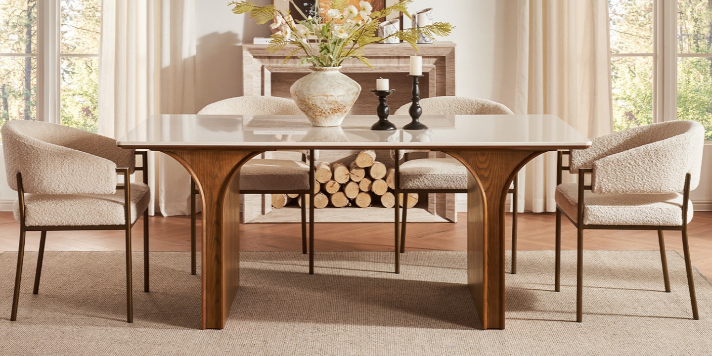 Matilda 72" unique dining table with an engineered stone top and architectural arched wood base in a bright dining room. Matilda 72" unique dining table with an engineered stone top and architectural arched wood base in a bright dining room.