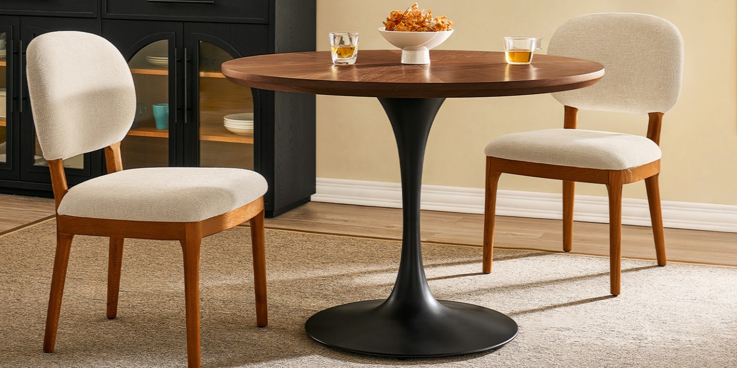 Perfect for cozy spaces, the Estelle 42" round dining room table pairs a bronze carbon steel base with a warm wood top. Perfect for cozy spaces, the Estelle 42" round dining room table pairs a bronze carbon steel base with a warm wood top.