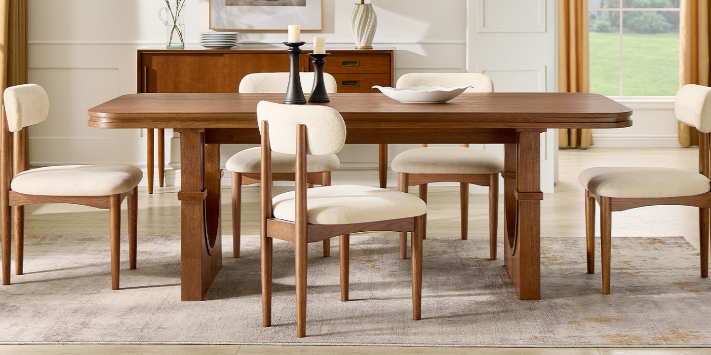 Solvind 84-inch oak dining table featuring a unique architectural arched base in a sunny dining space. Solvind 84-inch oak dining table featuring a unique architectural arched base in a sunny dining space.