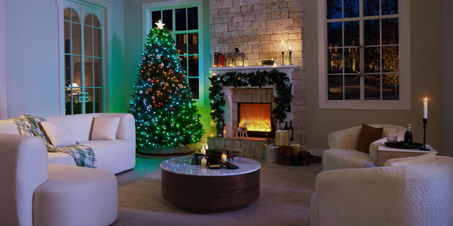 Cozy Christmas corner: The central tree, glowing with multi-colored lights, is perfectly placed between two windows and beside a lit stone fireplace, anchoring the festive atmosphere. Cozy Christmas corner: The central tree, glowing with multi-colored lights, is perfectly placed between two windows and beside a lit stone fireplace, anchoring the festive atmosphere.