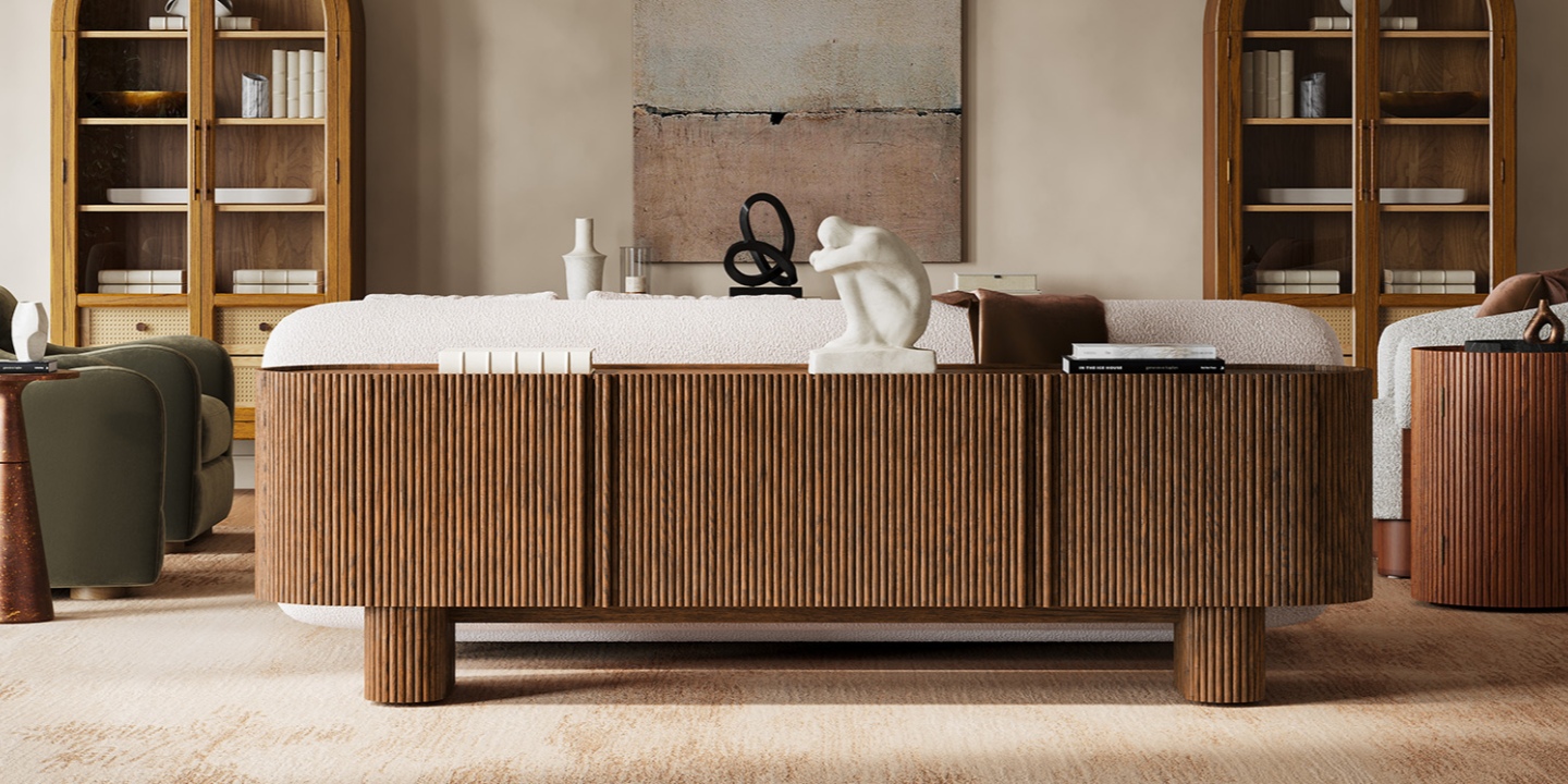 The Marisol 84" oak media console features fluted textures and rounded ends, beautifully styled in a warm living room. The Marisol 84" oak media console features fluted textures and rounded ends, beautifully styled in a warm living room.