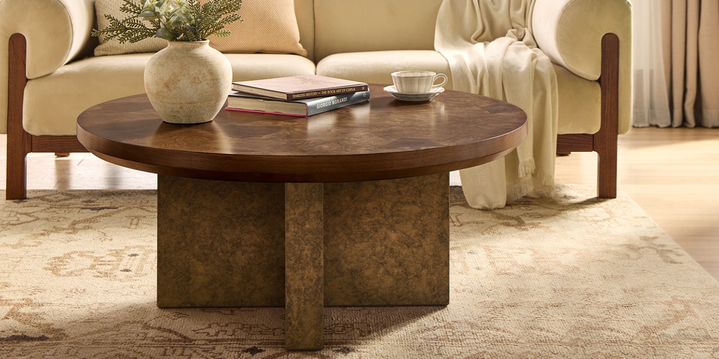 A round burl wood coffee table in a bright living room, featuring a vase of roses and a decorative bowl as a chic decor idea. A round burl wood coffee table in a bright living room, featuring a vase of roses and a decorative bowl as a chic decor idea.