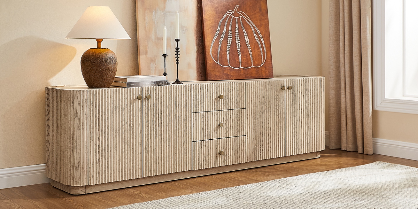 Skimra 84-inch whitewashed oak fluted TV stand with wave-inspired texture and sleek hardware in a bright living room.