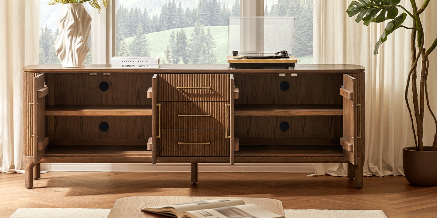 Skugga 84-inch kiln-dried solid oak media console highlighting durable construction and open storage in a sunny living room. Skugga 84-inch kiln-dried solid oak media console highlighting durable construction and open storage in a sunny living room.