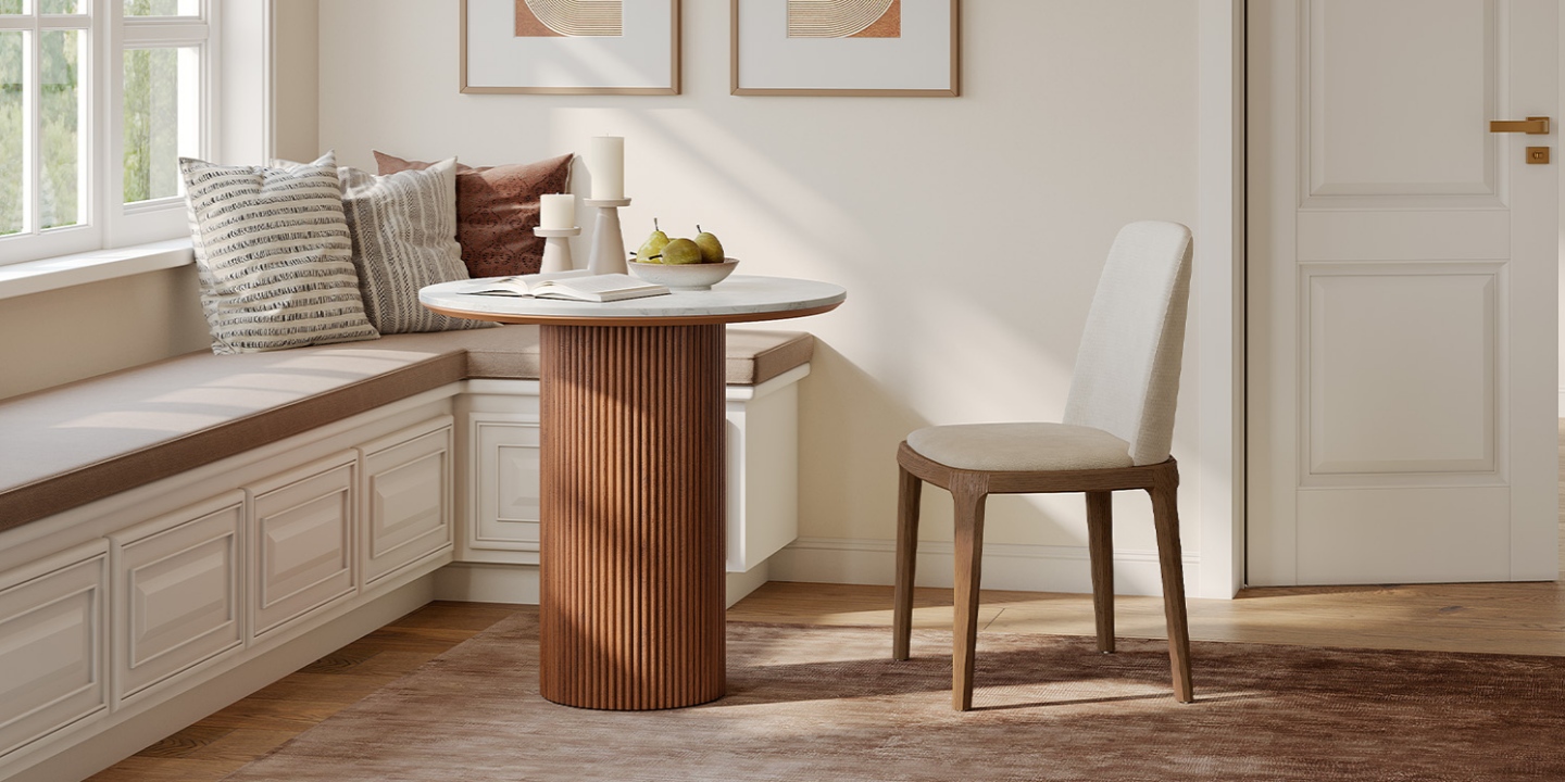 Nestled in a cozy breakfast nook, the Rolf 31" round dining room table features a fluted wood base and engineered stone top. Nestled in a cozy breakfast nook, the Rolf 31" round dining room table features a fluted wood base and engineered stone top.