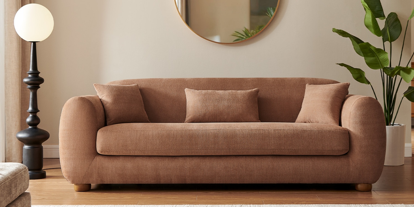 Sirocco chenille Frosta sofa with a rounded silhouette and soft curved lines, styled with accent pillows in a warm room. Sirocco chenille Frosta sofa with a rounded silhouette and soft curved lines, styled with accent pillows in a warm room.