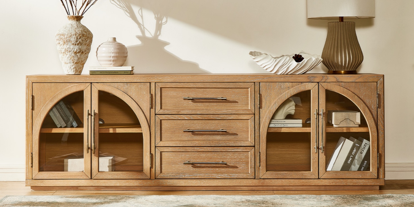Offering an 80.1-inch tv stand width, this Valborg oak media console features arched glass cabinets and central drawers. Offering an 80.1-inch tv stand width, this Valborg oak media console features arched glass cabinets and central drawers.