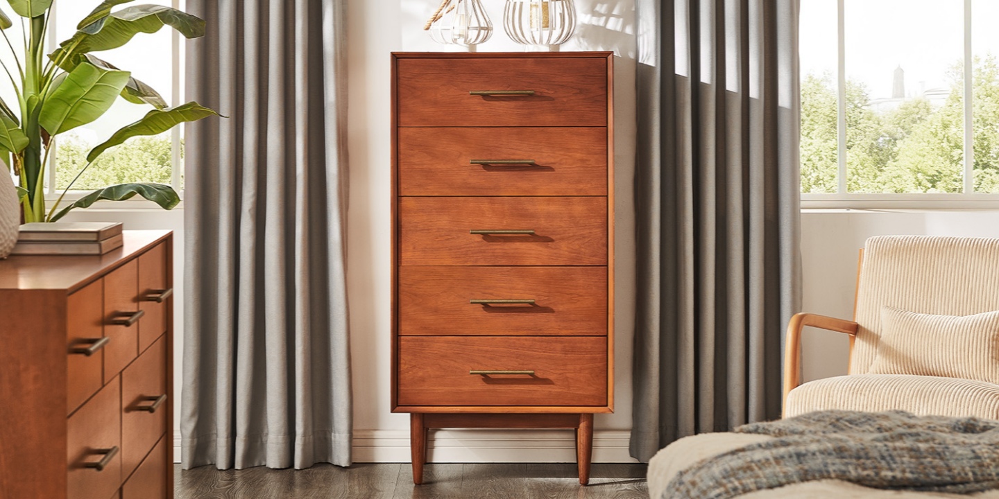 This 26-inch Kaden mid-century chest in a warm cherry finish features five drawers, antique bronze hardware, and tapered legs. This 26-inch Kaden mid-century chest in a warm cherry finish features five drawers, antique bronze hardware, and tapered legs.
