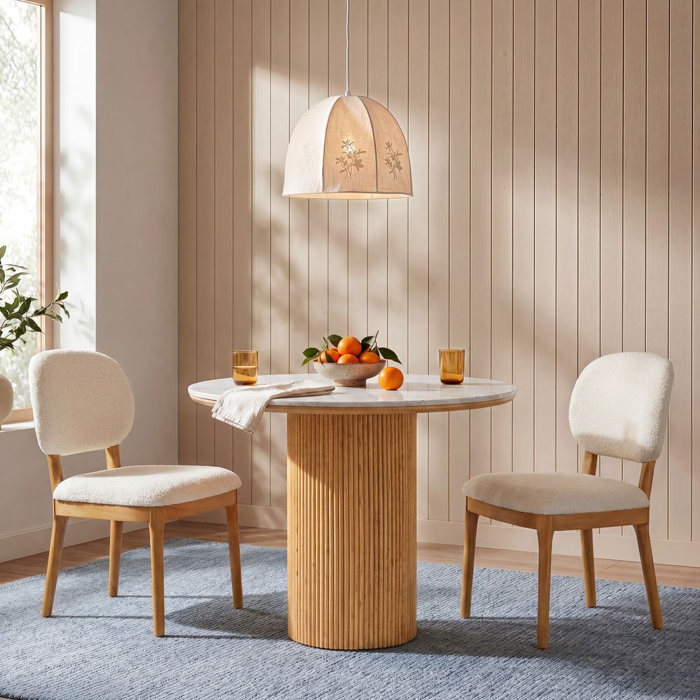 Hernest Rolf 39 inch Dining Table with white engineered stone top and fluted wooden base styled in a warm, modern dining room setting.