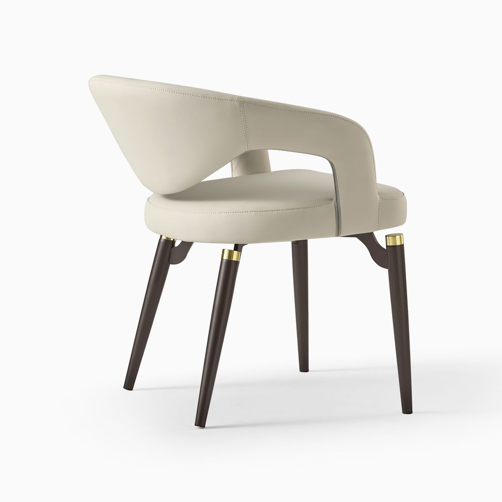 Close-up of the Hernest Liliana Armrest Leather Dining Chair, highlighting the stitched beige PU leather seat and the leg accent.