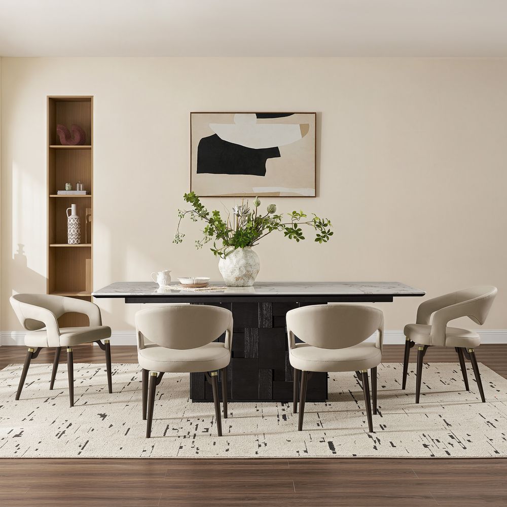 Side view of the beige Hernest Liliana Armrest Leather Dining Chair, featuring a curved cutout back and legs with elegant golden metal accents.