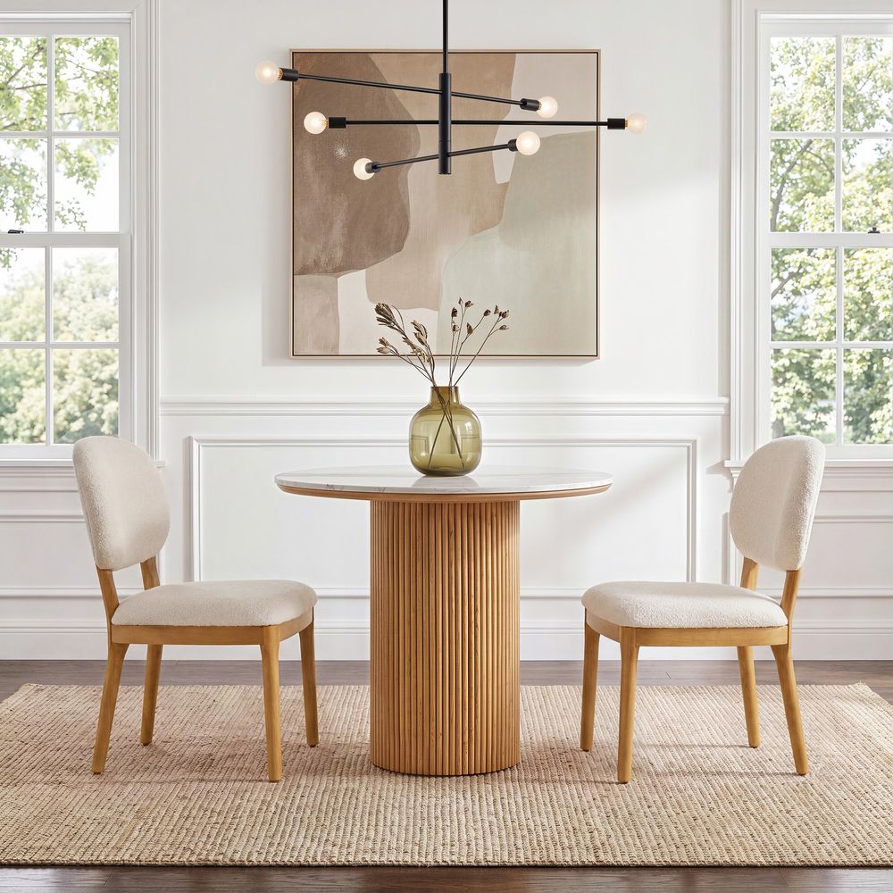 Hernest Rolf 39 inch Dining Table with white engineered stone top and fluted wooden base styled in a warm, modern dining room setting.