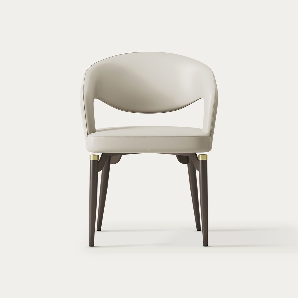 Front view of the beige Hernest Liliana Armrest Leather Dining Chair, featuring a curved back, black legs, and gold accents.