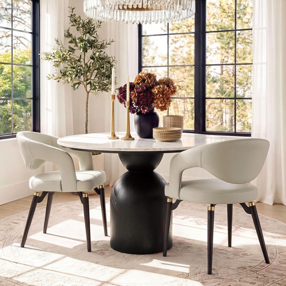 Orange DinTwo modern beige Hernest Liliana Armrest Leather Dining Chairs with curved backs and gold-accented black legs, shown together.ing Chair Set