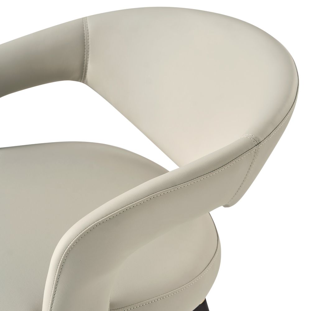 Close-up of the Hernest Liliana Armrest Leather Dining Chair, highlighting the curved armrest, beige PU leather seat, and golden leg accents.