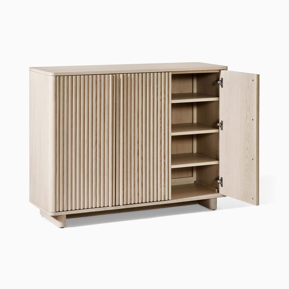 A shoe cabinet with one door open