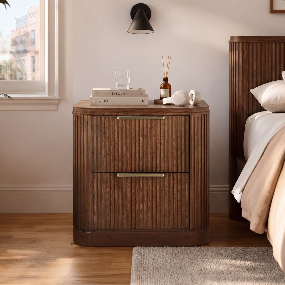 Hernest Finnley 26 inch Fluted Nightstand in a bedroom setting, showcasing two drawers with metal hardware and a sophisticated fluted design.