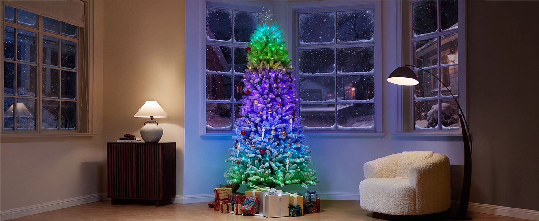 CastGlow 6.5 ft pre-lit slim flocked artificial Christmas tree glowing with vibrant gradient RGB lights in a cozy living room.