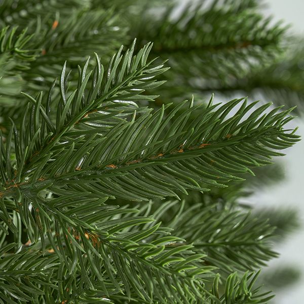 Close-up detail of the ultra-realistic natural green 3D PE needles and branch texture of the CastGlow slim tree.
